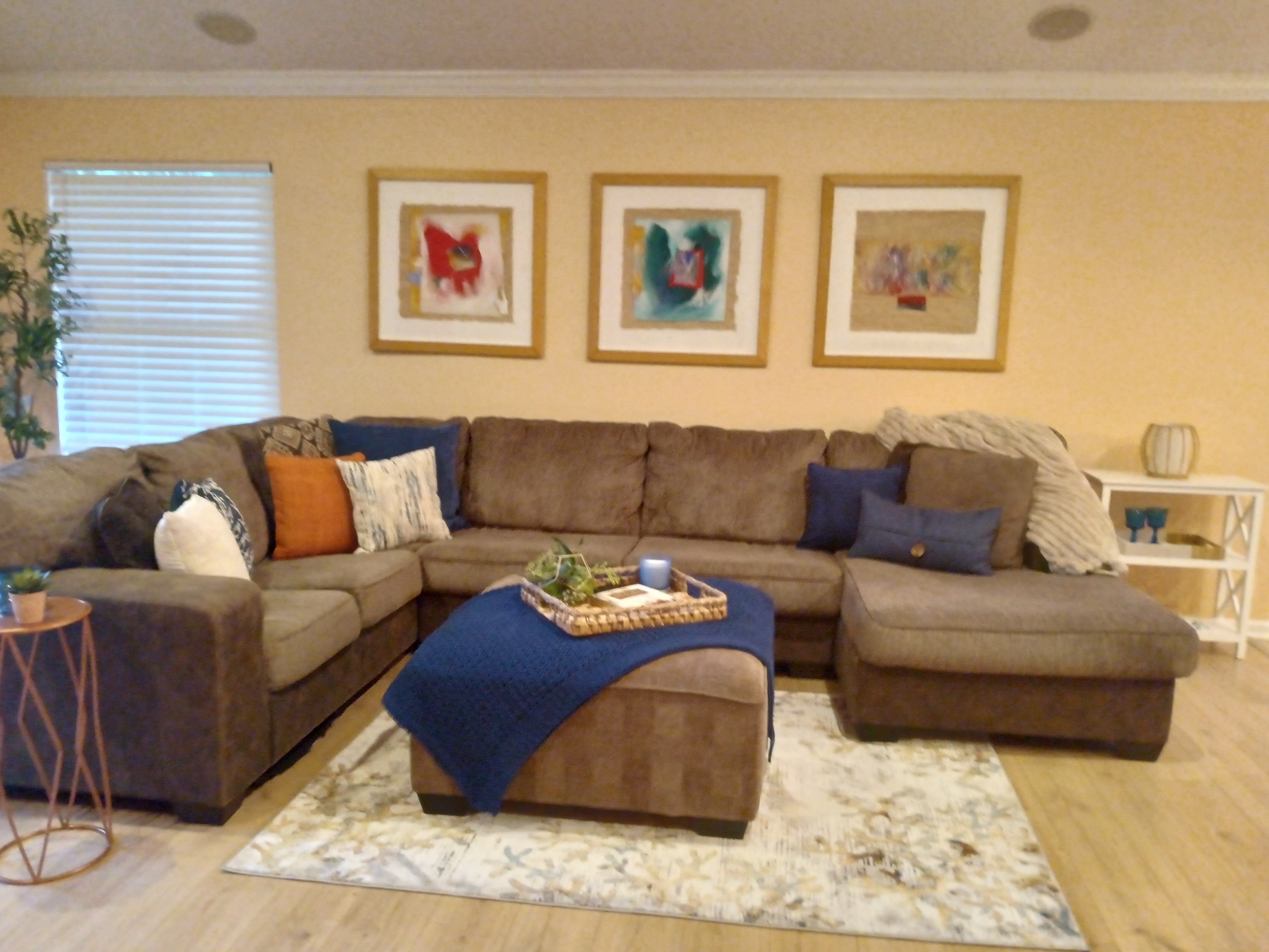 Warm living room with large sectional and abstract art